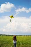 Little girl with flying a kite