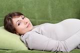 Young pregnant woman relaxing on sofa