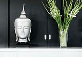 contemporary interior design detail with buddha image and flower