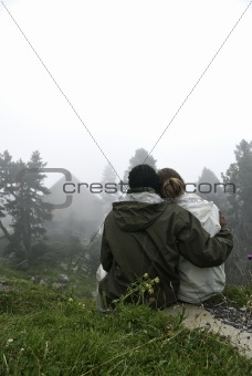 Couple looking at misty winter landscape