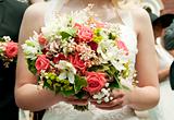 bride holding bunch of flowers at wedding