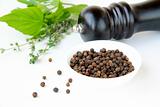 black pepper in a bowl and herbs