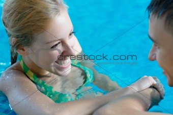 Girl flirting with a boy at the pool