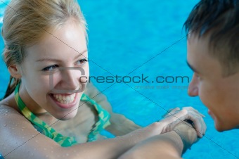 Girl flirting with a boy at the pool
