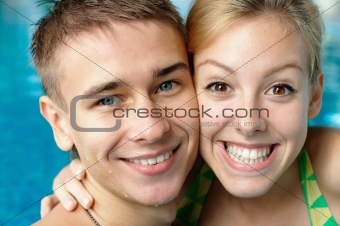 Smiling young couple at the pool