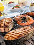 Salmon And Prawns Cooking On A Grill