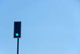 Green Traffic Light Against A Blue Sky