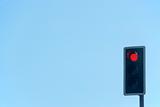 Red Traffic Light Set Against A Blue Sky