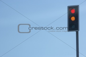 Red Traffic Light Set Against A Blue Sky