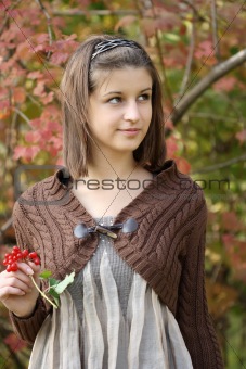 Young girl in the autumn forest