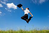 happy and successful businessman jumping on the field