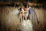 Kissing newlyweds in autumn field