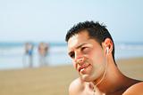 guy on the beach  listening to music
