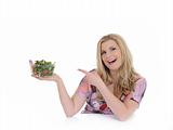 Casual woman eating healthy green vegetable salad. isolated