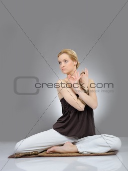 Creative portrait of young woman in yoga relaxation pose