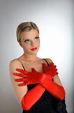 Portrait of sexy fashion woman with red lips and gloves looking 
