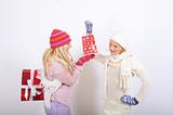 Two pretty winter girls friends making presents