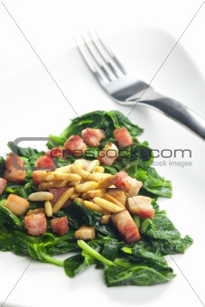 fried spinach with bacon and pine nuts
