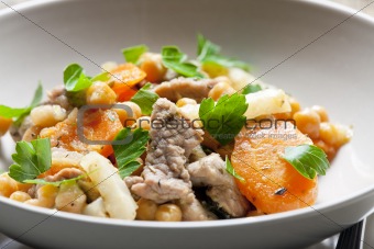 pork meat on celery with carrot and chick peas