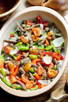 beef meat with peppers, onion and capers