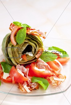 cooked artichoke with tomatoes, parmesan cheese, pancetta, and mint