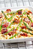 pasta baked with dried tomatoes, asparagus and pecorino cheese