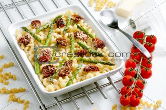 pasta baked with dried tomatoes, asparagus and pecorino cheese