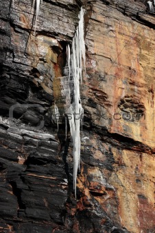 dripping frozen icicles on a cliff face