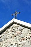 Cross from metal at old church roof