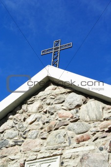 Cross from metal at old church roof