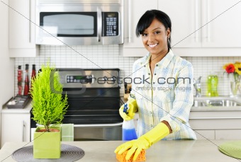Young woman cleaning kitchen