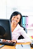 Happy black businesswoman at desk