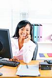 Smiling black businesswoman at desk