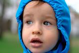Baby in a blue raincoat