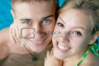 Smiling young couple at the pool