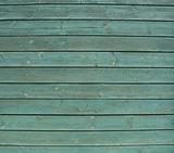 planks of green painted wooden timber fence                     