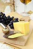 Cheese platter with grapes on a wooden  background