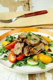 salad with duck breast, cherry tomatoes and arugula