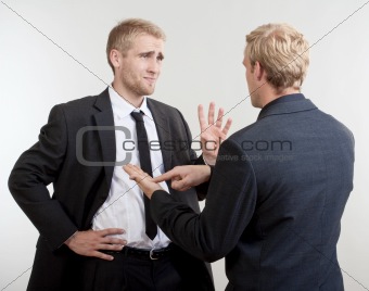 two you businessmen standing, discussing, arguing - isolated on light gray