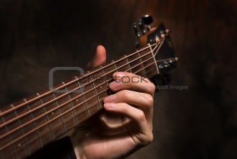 Close up acoustic guitar in musician hands