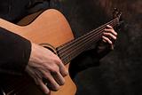 Close up acoustic guitar in musician hands
