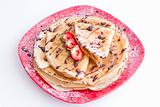 sweet pancakes with strawberries on red plate