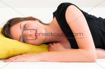 beautiful smile young woman with green pillow 