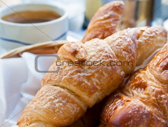 Breakfast with coffee and croissants on table