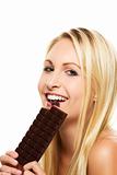 beautiful blonde woman eating a chocolate bar