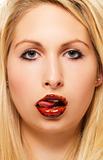 beautiful blonde woman licking chocolate from her chocolate covered lips