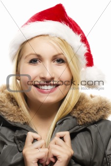 beautiful laughing blonde woman in a parka wearing santa's hat