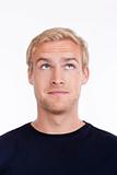 portrait of a young man with blond hair looking up - isolated on white
