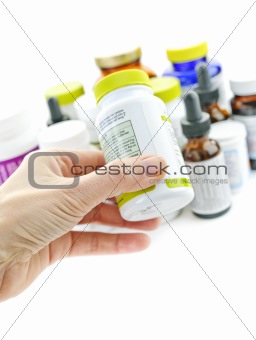 Hand holding medicine bottle