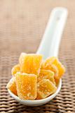 Candied ginger pieces in spoon